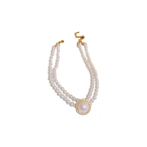 Elegant double-strand faux pearl necklace featuring a central rhinestone halo pendant