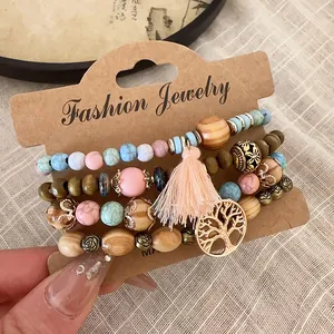Detailed view of bohemian multi-layer beaded bracelet with tassel and tree of life