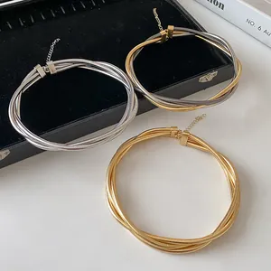 Set of three multi-strand metallic twisted choker necklaces in gold and silver finishes