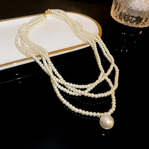 Detailed close-up of elegant multi-layered pearl necklace with a large round pendant