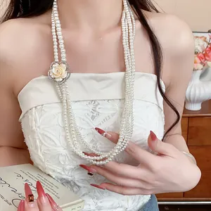Close-up detail of a French vintage multi-strand pearl necklace with a rhinestone flower.