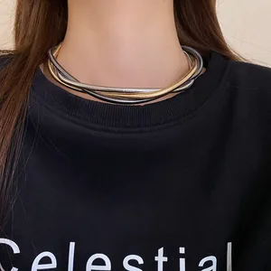 Detailed view of twisted multi-strand metallic choker necklace worn by a female model