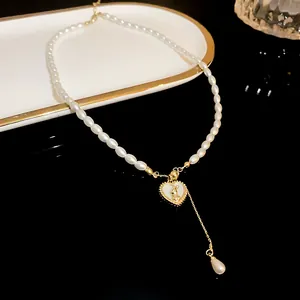 Elegant pearl necklace featuring a gold heart pendant with a rabbit motif and drop pearl.