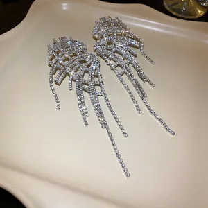 Macro detail of sparkling rhinestone tassel earrings with elegant dangling silver finish