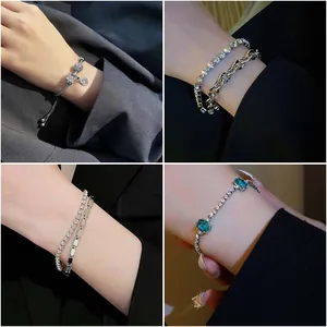 Detailed collage of four elegant sparkling zircon bracelets with emerald green stones