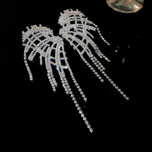 Exquisite close-up showing the sparkling rhinestone tassels and irregular wing design details