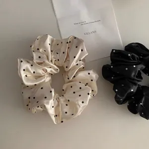 Elegant satin polka dot scrunchies for women in cream and black minimalist style