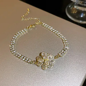 Close-up detail of double-row zircon pavé bracelet with a large sparkling flower center