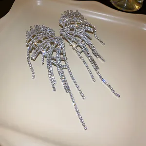 Detailed view of sparkling rhinestone irregular tassel earrings with a long fringe design.