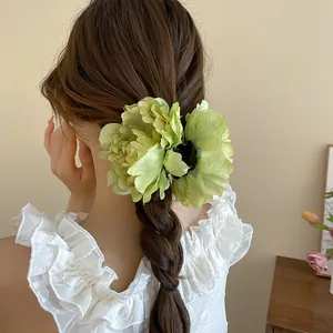 Large green floral hair claw clip with 3D peony design for elegant bun hairstyles