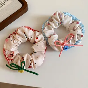 Close-up detail of floral and polka dot scrunchies with cute bow and button accents.