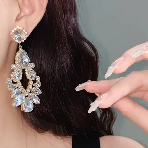 Exquisite silver needle teardrop tassel earrings with sparkling hollow diamond clusters.