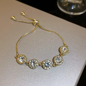 Detailed shot of gold bracelet featuring five circular clear zircon encrusted charms