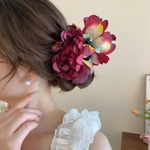 Large burgundy 3D flower hair claw clip worn on model's hair