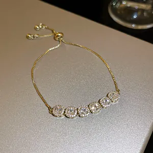 Detailed close-up of a sparkling gold-plated adjustable bracelet with zircon stones