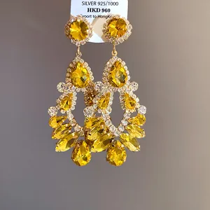 Close-up of yellow water drop tassel earrings with silver needle and rhinestones