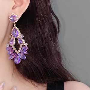 Detailed close-up of a sparkling purple crystal chandelier earring worn by a model