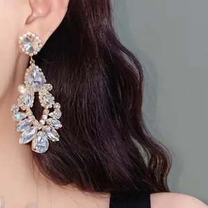 Close-up detail of luxurious crystal chandelier teardrop earrings with silver needles