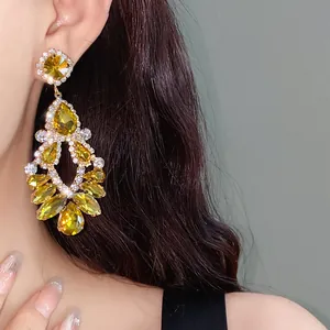 Detail of luxurious palace style chandelier earrings with yellow crystals and silver needles