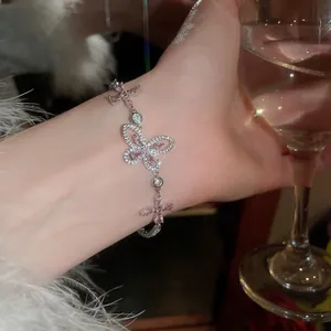 Elegant silver bracelet with pink butterfly zircon charms, perfect for evening wear.