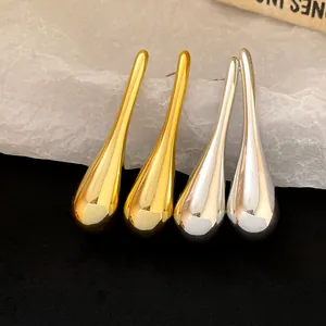 Close-up detail of sleek gold and silver waterdrop earrings featuring high-shine finish