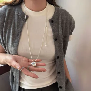 Detailed view of silver brushed heart pendant on an adjustable sliding necklace chain.
