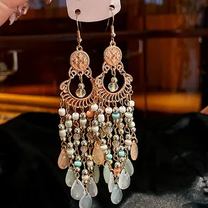 Detail view of bohemian tassel earrings with colorful beads and crystal drops.