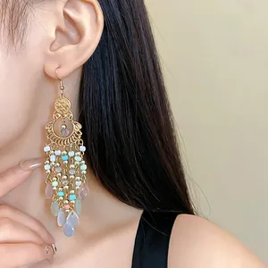 Close-up detail of bohemian vintage long tassel earrings with colorful crystal beads