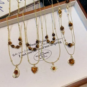 Vintage Tiger's Eye beaded necklaces in gold finish with heart and sun pendants