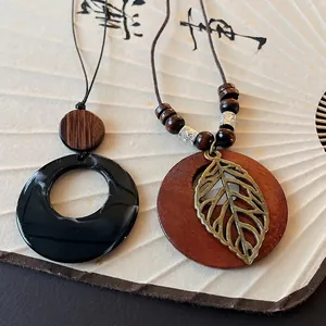 Vintage ethnic style long sweater chain with round pendants and hollow leaf charm