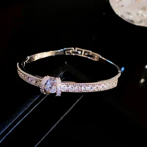 Macro detail of elegant silver-colored bracelet with sparkling cubic zirconia stones.