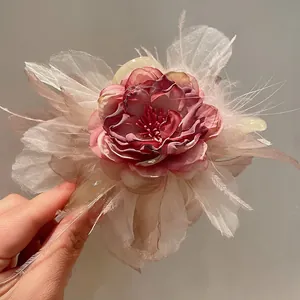 Primo piano dettagliato della molletta per capelli a fiore stile foresta con piume leggere