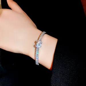 Close-up of elegant silver zircon bracelet featuring sparkling rhinestones on wrist.