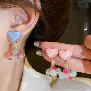 Detailed close-up of sweet colorful heart-shaped glass beaded earrings for women