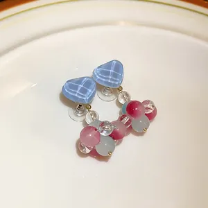 Macro detail of sweet style heart earrings with multicolored glass bead clusters