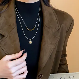 Elegant close-up of double-layered tiger eye beaded necklace with sun pendant on model