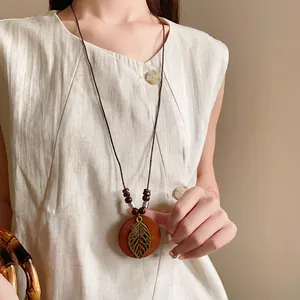 Vintage wooden necklace with hollow leaf pendant and bead accents