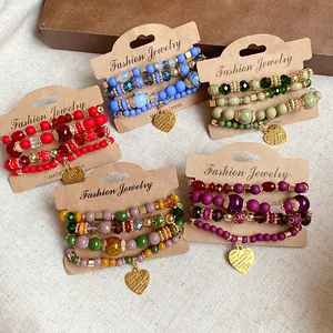 Five sets of colorful layered acrylic crystal beaded bracelets with heart charms