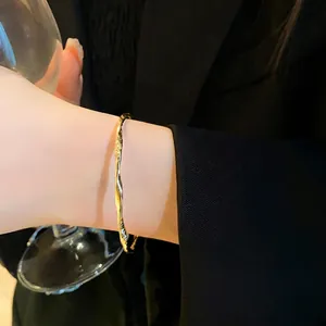 Elegant minimalist gold twisted open bangle bracelet with stylish geometric design for women