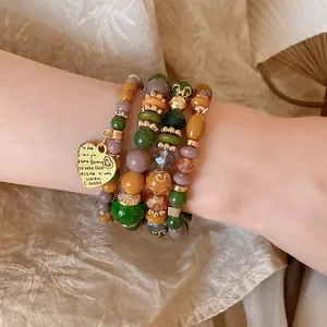 Close-up of vintage ethnic style acrylic beaded bracelet with heart charm