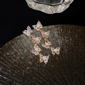 Elegant gold-plated butterfly tassel earrings featuring sparkling cubic zirconia crystals