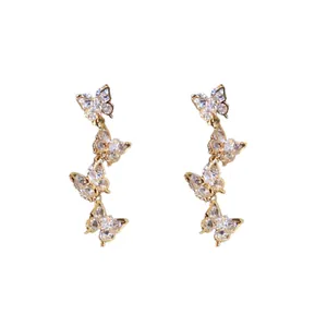 Elegant gold butterfly tassel earrings with sparkling cubic zirconia on a white background
