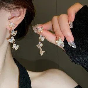 Close-up of cascading zircon butterfly tassel earrings with elegant sparkling details.