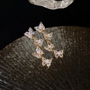 Close-up of elegant butterfly tassel earrings with sparkling cubic zirconia crystals