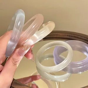 Detailed view of translucent pastel resin bangles with a smooth and glossy finish