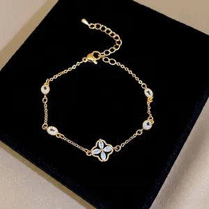 Elegant gold-plated flower bracelet with sparkling zircon stones on black background.
