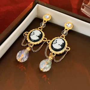 Elegant vintage-style cameo drop earrings featuring black portraits and iridescent crystals