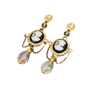 Vintage black cameo drop earrings with gold chains and faceted crystal teardrops