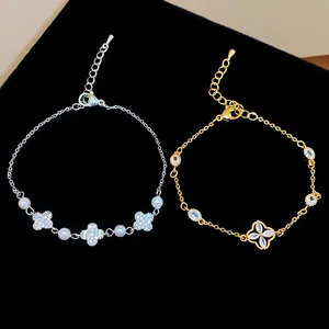 Close-up of elegant gold and silver flower bracelets featuring zircon and pearls
