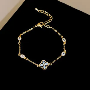 Close-up of gold-plated flower bracelet with sparkling zircons on black velvet background.